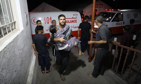 Injured Palestinians, including children, are brought to al-Ahli Baptist hospital for treatment after an Israeli attack on Jabalia refugee camp in Gaza City on Friday