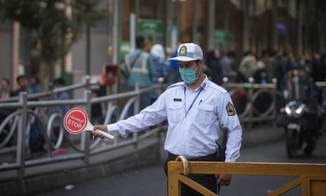 A police officer wearing a face mask works on a street in Tehran, Iran.