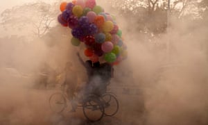 A rickshaw puller on a polluted a street in Dhaka, Bangladesh.