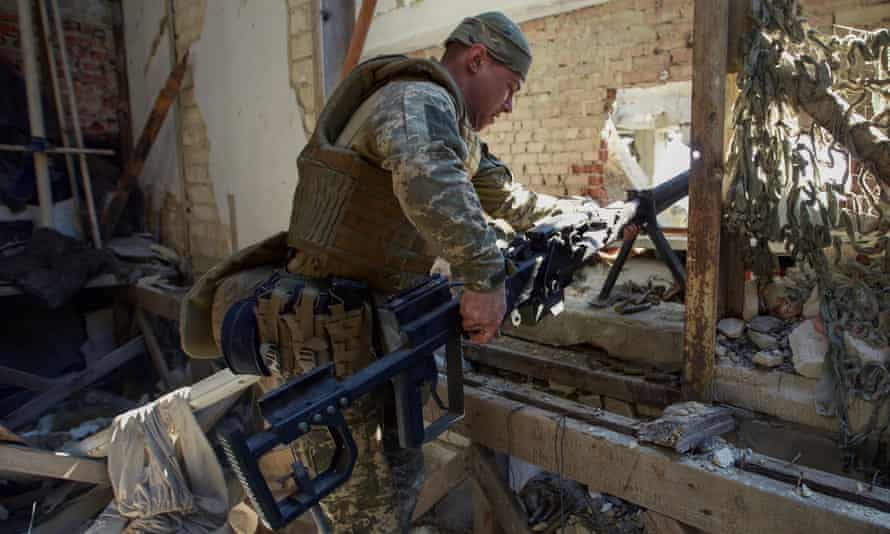 A Ukrainian serviceman sets up an anti-materiel rifle at a position in the town of Marinka, Donetsk region.