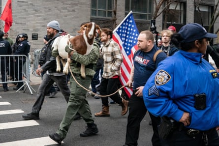 Far-right activist Jake Lang leaves with members of the ‘End Islamification’ rally while carrying a goat outside of Grace Mansion in New York City on Saturday.