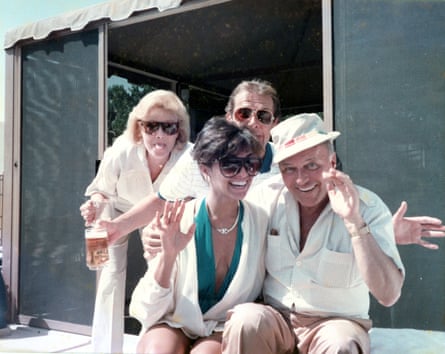 Four people – two women and two men - looking very happy and wearing white shirts
