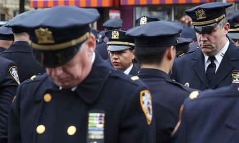 Law enforcement officers stand, with some turning their backs, as New York City Mayor Bill de Blasio speaks at the funeral of Wenjian Liu.