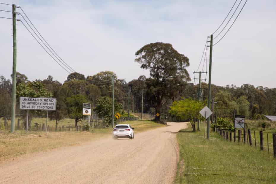 A car drives down a dirt backroad in the Hunter Valley