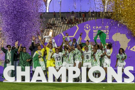 Nigeria’s players celebrate with the trophy on the podium after winning the 2025 Women’s Africa Cup of Nations final