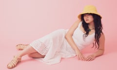 Model lying down in hat and boho chic dress