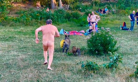 A naked sunbather chases after a wild boar