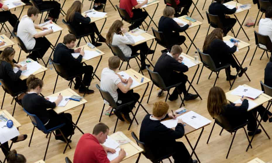 Rows of students at desks sitting their GCSE examinations,s een from above