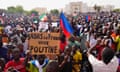 FILE - Nigeriens participate in a march called by supporters of coup leader Gen. Abdourahmane Tchiani in Niamey, Niger, Sunday, July 30, 2023. The French troops being forced out of Niger were seen as a key line of decadelong defense amid efforts led by the West, particularly U.S. and France, to fight against jihadi violence in Africa’s hard-hit Sahel region. The sign reads: "Down with France, long live Putin." (AP Photo/Sam Mednick, File)