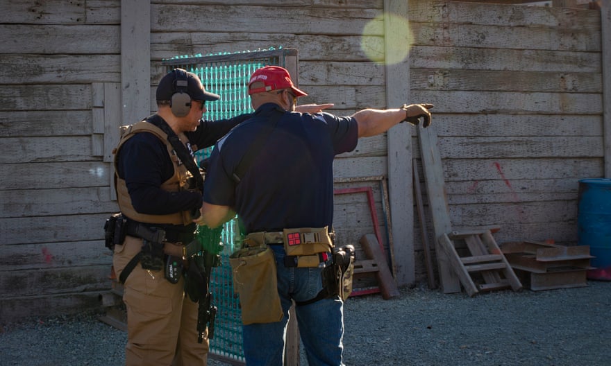 A veteran firearm instructor with the Black Gun Owners Association gives pointers during a drill at the Richmond Rod &amp; Gun Club.