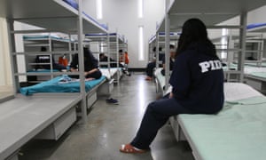 Female detainees sit on their bunks in the dormitory of the Alpha Unit at Port Isabel detention facility in Texas.