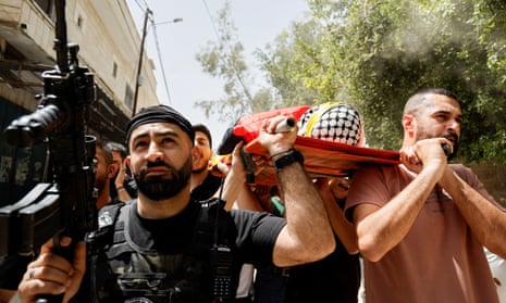 Mourners carry the body of Khaled Raed Arouq, 16, who was killed in an Israeli raid, during his funeral in Jenin, in the Israeli-occupied West Bank on 25 April.