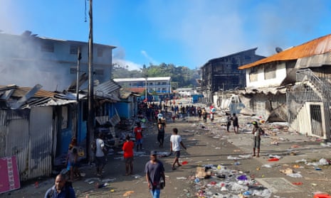 Smoke rises from burnt out buildings in Honiara's Chinatown.