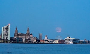 The full moon rises over Liverpool, Merseyside, United Kingdom.