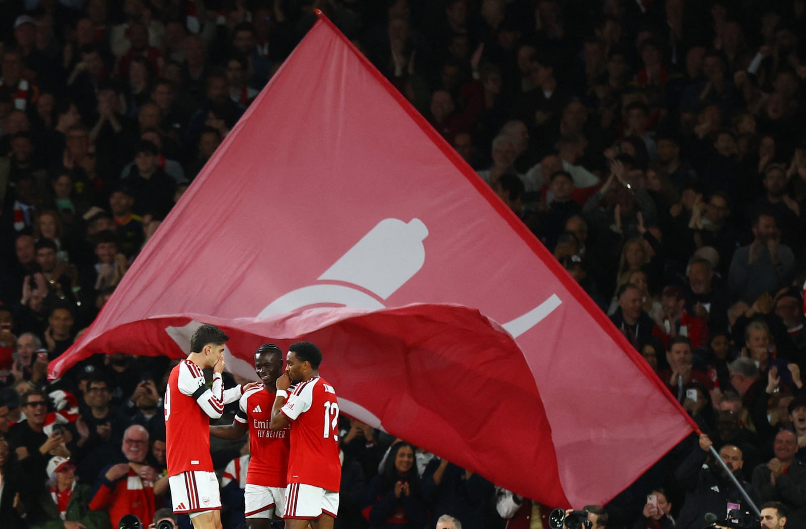 Bukayo Saka celebrates Arsenal's third goal with Kai Havertz and Jurriën Timber