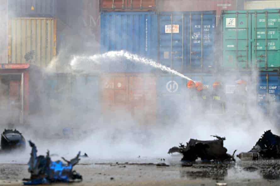 Firefighters try to extinguish the fire.
