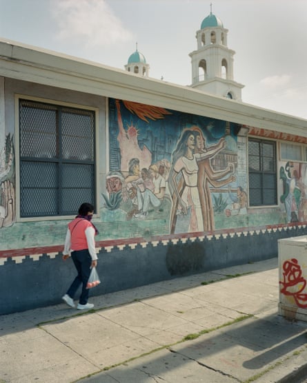 The mural, Homage to America, by muralist Jose Meza Velasquez, is painted on the side of a United States Postal Service building in Fruitvale, California.