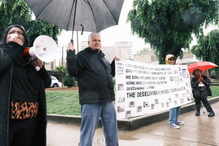 People with signs and a megaphone.
