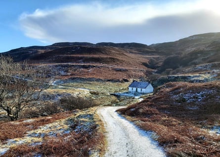 A small whitewashed bothy ibn a remote, frosty landscape