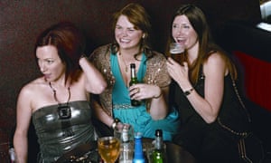 A scene from Pulling with the three women flatmates in a pub, laughing and drinking