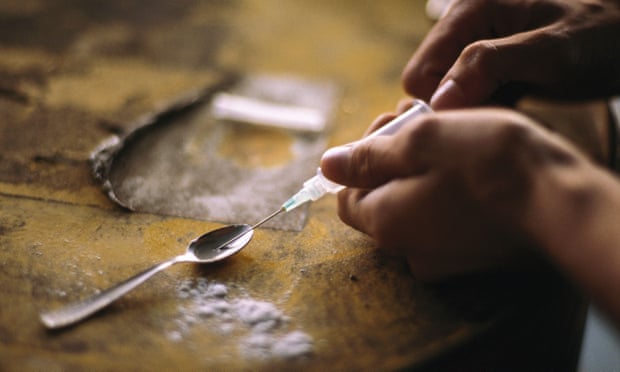 Person preparing syringe of crack cocaine