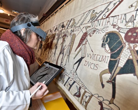 A technician inspecting the tapestry