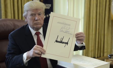 Donald Trump signs Republican tax cuts into law.