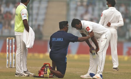 A paramedic speaks to Sri Lanka’s Lahiru Gamage after he complained of shortness of breath.