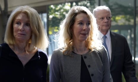 Elizabeth Holmes with her parents, Noel and Christian, as they arrive in court on 1 September.
