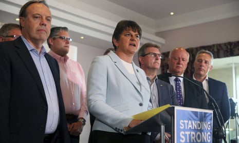 Democratic Unionist party leader Arlene Foster speaks to the media surrounded by her MPs