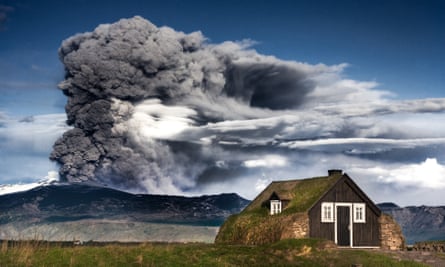 the eruption of eyjafjallajökull, iceland, 2010, with a turf-roofed cottage in the foreground