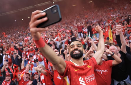 Mohamed Salah takes one of many selfies with the fans as they celebrate the Premier League title at Anfield after thrashing Tottenham 5-1
