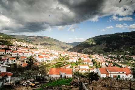 A small town with white red-roofed houses in a green valley