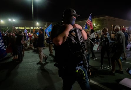 A gun-toting Trump supporter attends a protest in the parking lot at the Maricopa county tabulation and election center on 5 November 2020 in Phoenix, Arizona.