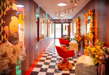 artwork and flowers line hallway with tiled floor