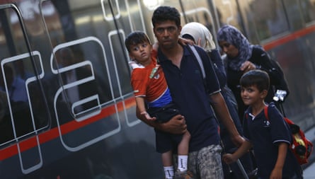 A family disembarks from a Railjet train from Austria