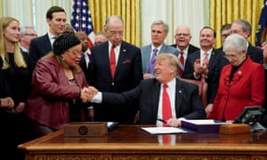 Donald Trump shakes hands with Alveda King during a signing ceremony for the First Step Act at the White House on 21 December.