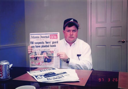Richard Jewell holding a copy of the paper naming him as a suspect
