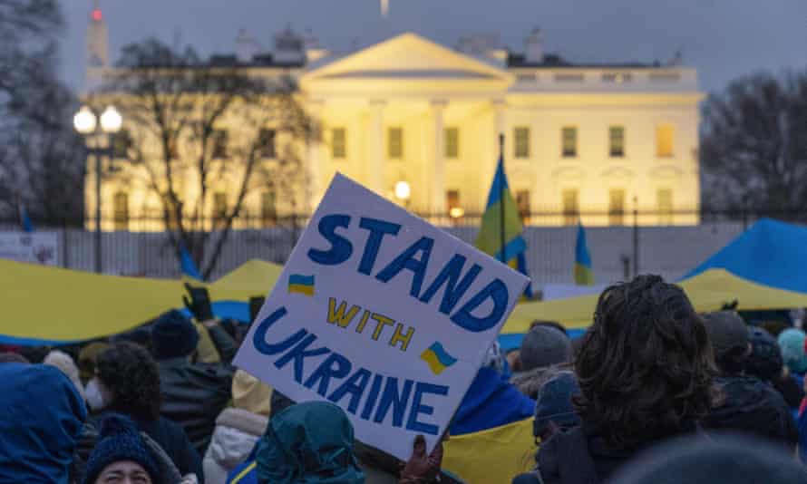 People take part in a vigil to protest the Russian invasion of Ukraine in front of the White House.