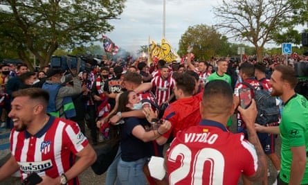 Atlético Madrid players celebrate with their fans outside Real Valladolid‘s Estadio Municipal Jose Zorrilla after winning La Liga in May 2021.