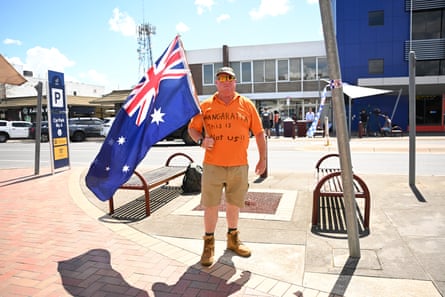 Chris Wernet wears a T-shirt emblazoned with ‘Wangaratta this is not us’ as he waves an Australian flag on Tuesday.
