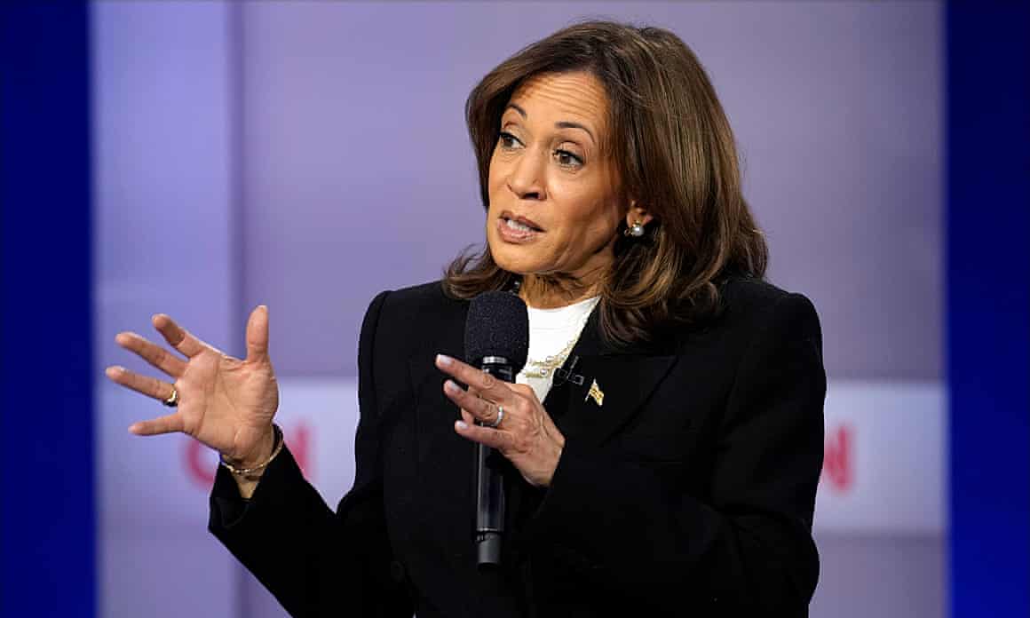 Kamala Harris gestures while looking to the side
