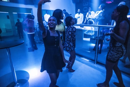 A woman takes a selfie on the nightclub dancefloor