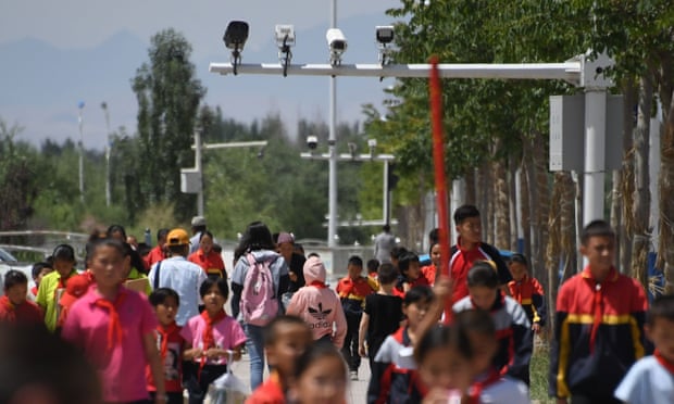 Schoolchildren walking below surveillance cameras in Akto, south of Kashgar, in China’s western Xinjiang region
