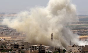 Smoke rises following a reported airstrike in the town of Khan Sheikhun, Idlib