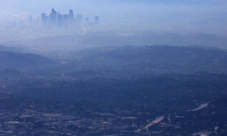 Buildings of downtown Los Angeles partially obscured at midday.