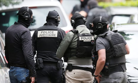 Police officers during an operation to arrest the suspects, in Oullins, near Lyon.