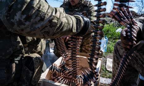 Ukrainian troops put bullets into clips for use with light machine-guns in training as its forces ready for the spring counteroffensive