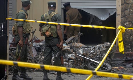 Members of the Sri Lankan military stand guard near an explosion site at a church in Batticaloa