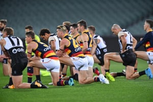Players kneel for Black Lives Matter during the round 2 AFL match between the Port Adelaide Power and the Adelaide Crows in Adelaide on 13 June